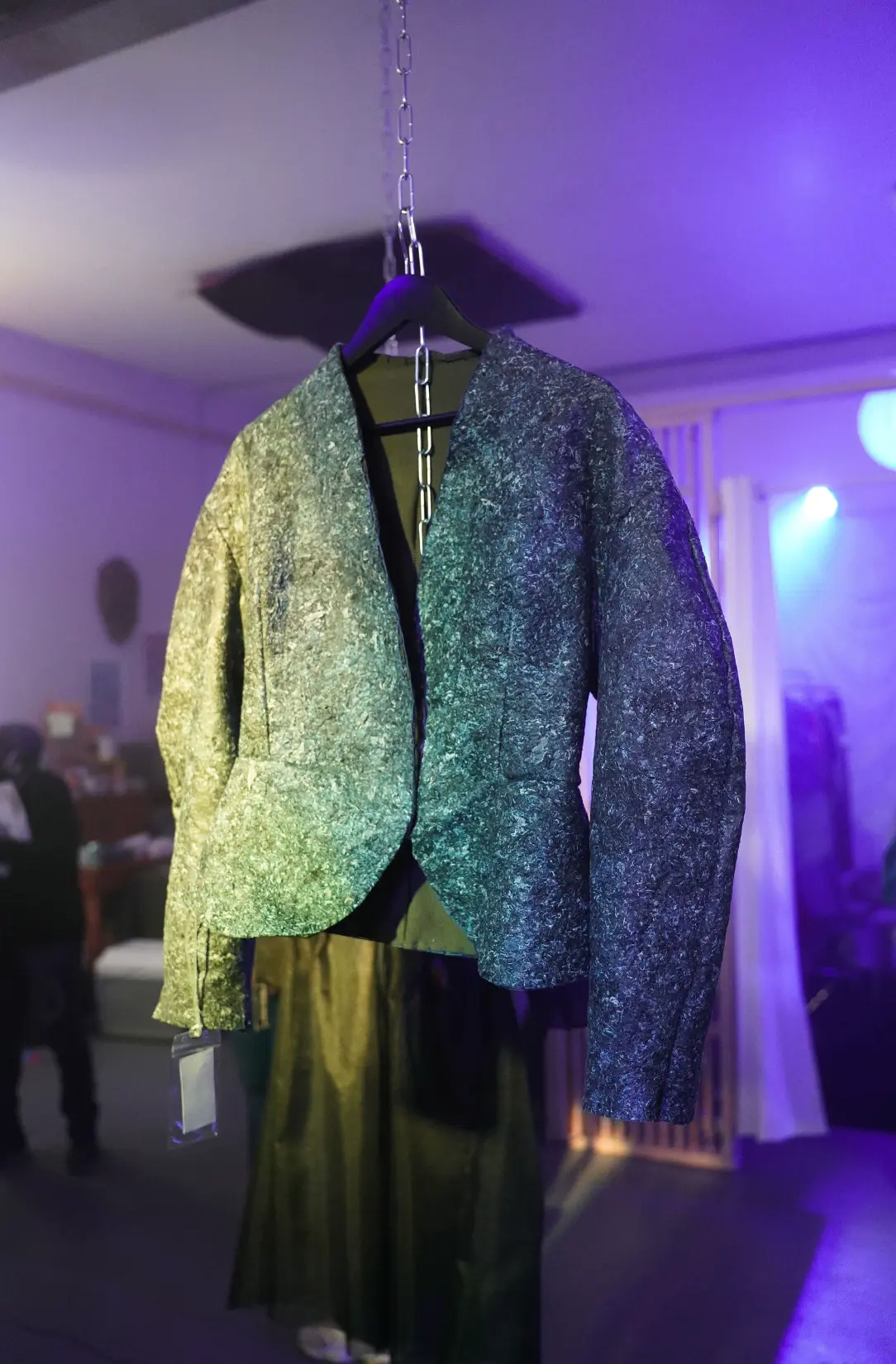 A textured jacket suspended by a chain at the Collective Power exhibition