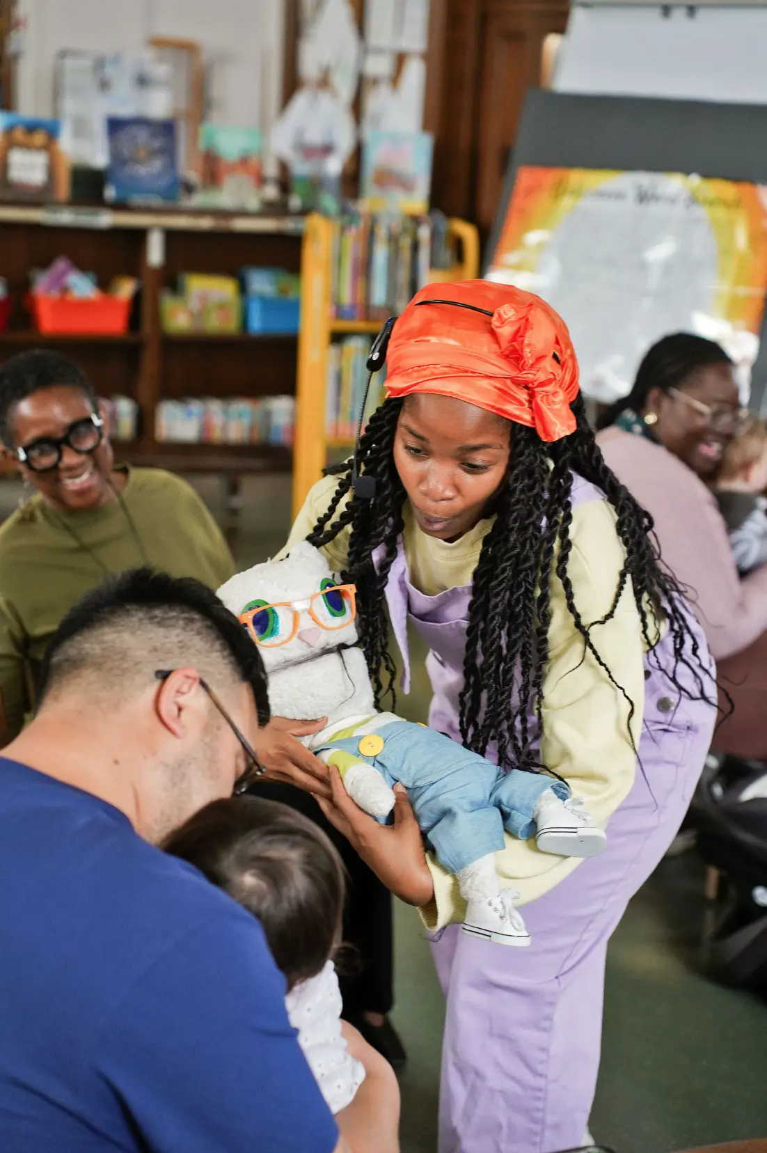 Sierra Boone introducing Bahb the sheep puppet to a family at the library