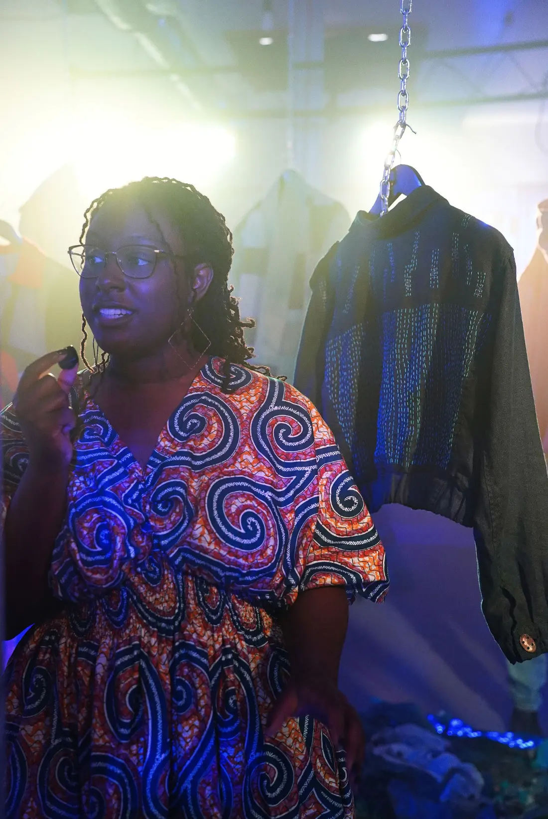 A visitor standing beside a dark jacket at the Collective Power exhibition