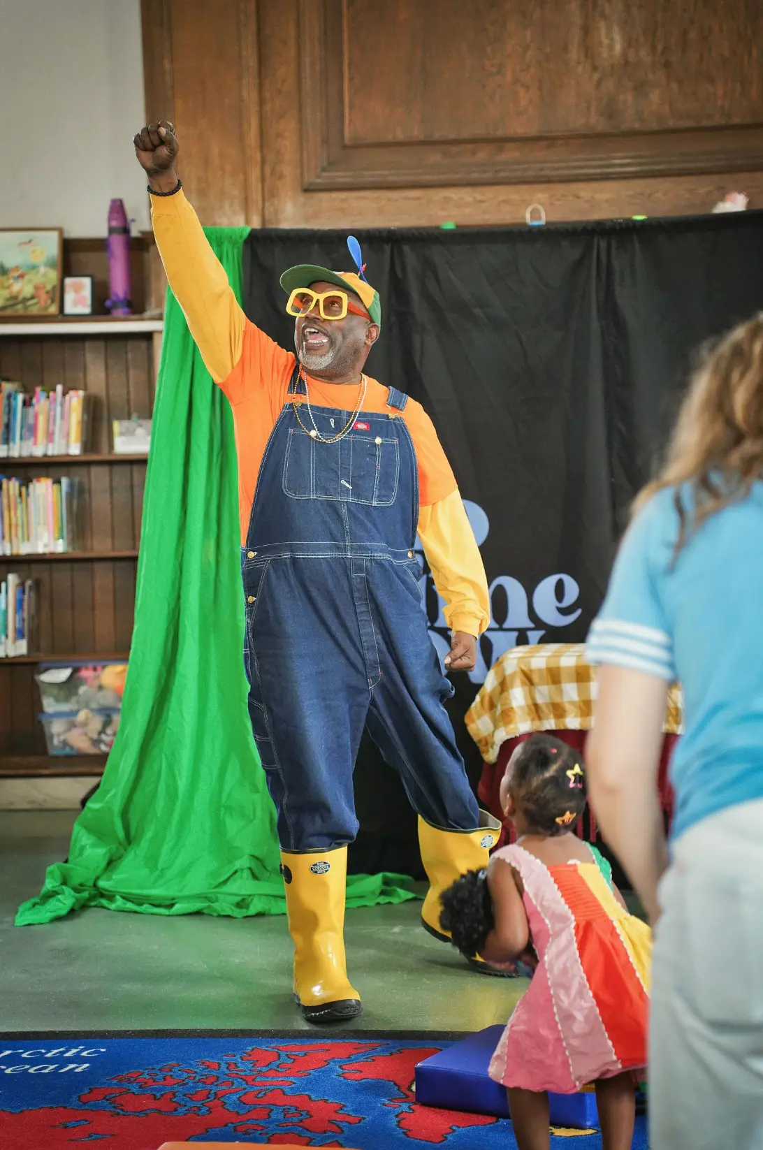 Mr. Boots raising his arm during the Duffield Library performance
